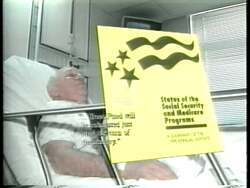 ["In a 1996 TV ad, Republican Mark Neumann addresses anxieties surrounding Medicare's future. Elderly individuals are seen worriedly discussing and reviewing Medicare details, while a confident Neumann presents his plan for enhancing and safeguarding the program. Scenes underscore the potential benefits of his plan, aligning with senior citizens' concerns."]