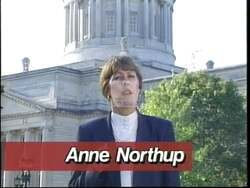 ["In her 1996 political TV ad, Republican Anne Meagher Northup confidently campaigns from a podium. She emphasizes her commitment to strong leadership and community values while addressing various attentive audiences. Her consistent message focuses on advocating for impactful legislative actions and dedication to pressing issues, underscoring her readiness for Congress."]