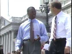 ["In the 1996 presidential campaign ad for Republican Julius Ceasar Watts, he stands confidently before Congress, passionately advocating for welfare and budget reforms, emphasizing family values and the spirit of Oklahoma. His powerful oration from the podium symbolizes strong leadership and a committed stance on necessary governmental reforms."]
