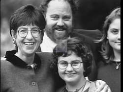 ["In her 1996 presidential campaign ad, Democratic candidate Arnie (Deborah) Arnesen passionately advocates for stronger healthcare, education, and pension systems. Through a series of speeches, Arnesen addresses vital social issues, engaging with an attentive audience and exemplifying strong leadership. The ad juxtaposes her advocacy with scenes of a working mom, emphasizing the everyday relevance of Arnesen's policies."]