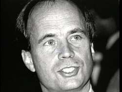 ["In the 1996 political ad for Democratic candidate Arnie (Deborah) Arnesen, scenes highlight the adverse effects of Congressman Bass's decisions on seniors. It encompasses personal testimonials from elderly individuals discussing struggles with heating due to Bass's cuts in senior fuel assistance, spotlighting his perceived neglect towards vulnerable seniors' well-being in a clean, professionally-styled interview setting."]