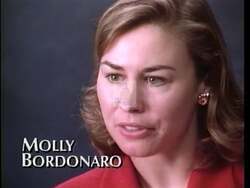 ["The 1996 political TV ad for Republican Party candidate Molly Bordonaro focuses on opposing government-run health care plans, emphasizing personal dedication and reformist zeal. The ad features scenes of Bordonaro and a man in a suit discussing political goals, with backdrop elements like the American flag and campaign posters highlighting a patriotic and determined atmosphere. Their messages target defeating Clinton's health care proposals."]