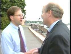 ["The 1996 political TV ad for Republican candidate John Edward Sununu features him advocating significant tax reductions to bolster families and support small businesses. Positioned confidently at podiums and surrounded by supportive crowds and small business owners, Sununu emphasizes his commitment to fiscal conservatism and economic reform. His confident demeanor and the visible enthusiasm of his supporters underscore his campaign message focused on tax cuts and family support."]
