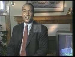 ["In the 1998 presidential campaign ad, Democratic candidate Michael Scott addresses voters with a series of earnest speeches. He promises to focus on key issues like safety, education, healthcare, and social security. Throughout the ad, he maintains a confident, sincere demeanor, emphasizing his dedication to public service and reform, all underscored by a backdrop of American symbols and campaign posters."]