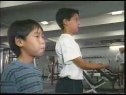["In the 1998 presidential campaign ad, Democrat Neil Abercrombie focuses on enhancing education and promoting physical fitness. He speaks passionately about raising educational standards in a classroom setting and is seen vigorously exercising in various gym scenes. The ad emphasizes his belief in the symbiotic relationship between mental sharpness and physical strength, showcasing his commitment to improving both educational policies and personal fitness."]