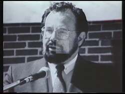 ["In a series of compelling scenes from his 1988 campaign ad, Democratic Party candidate Ken Hayes passionately advocates for enhanced community involvement, better leadership, and economic growth. Addressing crowds from various settings, he repeatedly emphasizes unity and change while engaging directly with constituents and workers, reinforcing his commitment to positive, actionable leadership."]