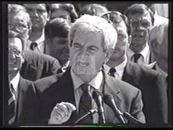 ["In the 1998 campaign TV ad, Democratic candidate Miles S. Rapoport forcefully addresses his opposition to Newt Gingrich's policies, particularly focusing on Gingrich's proposed cuts to Medicare, education, and Social Security. The ad portrays Rapoport as a determined advocate for the protection of these services, utilizing scenes of him speaking emphatically in various settings, including public forums and directly to the camera, underscored by imagery of vulnerable seniors and schoolchildren to emphasize the human impact of such cuts."]