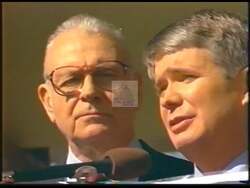 ["In his 2000 presidential campaign ad, Democratic Party candidate John Kennedy Hamilton is depicted engaging passionately with supporters across various rallies. The ad showcases Hamilton speaking to, interacting with, and shaking hands with a diverse group of constituents, highlighting his hopefulness and connection with American workers and rallying crowds. His campaign is energized by supportive, cheering audiences, underlined by banners proclaiming his Democratic allegiance."]