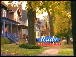 ["In Rudy Giuliani's 2000 presidential campaign ad, he consistently emphasizes his commitment to economic growth and job creation. Speaking confidently from a podium across various scenes, Giuliani promises economic stability and job opportunities for New York, using a backdrop of campaign banners and the American flag to underscore his message."]