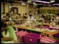 ["In the 1992 political TV ad for Democratic candidate John Knight, the ad shows him confidently addressing an enthusiastic crowd in Alabama, emphasizing themes of economic revitalization. He speaks from behind a podium, surrounded by campaign banners, outdoors, as the crowd listens attentively, signaling strong community support and engagement."]