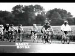 ["In her 2004 political TV ad, Democratic candidate Nancy Boyda is seen cycling through a small Kansas town, highlighting the visible economic decline and numerous empty storefronts. She expresses deep concern for the local economy and commits to addressing job losses and revitalizing the area if elected to Congress."]