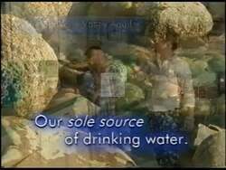 ["In his 2002 presidential campaign ad, Republican George R. Nethercutt emphasizes the importance of protecting the Spokane Valley Aquifer. He advocates for its sustainability, displaying its significance to regional health and the economy, illustrated through scenes of him speaking and animations of clean water flows."]