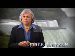 ["In the 2008 presidential campaign ad, Democratic candidate Alice Kryzan passionately advocates for renewable energy, using scenic and historic settings to emphasize its benefits for economic growth, national security, and job creation. She confidently traverses locations such as riversides, wind turbine fields, and a factory to showcase her commitment to sustainable development and the revitalization of American industry through green energy initiatives."]
