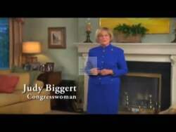 ["In a 2008 TV ad, Republican candidate Judy Borg Biggert confidently addresses economic challenges. She promises to protect savings, fight unfair tax increases, and ensure fiscal fairness from various settings including her office and a podium adorned with a \"Vote Beggar\" banner, emphasizing her commitment to economic stability and oversight."]