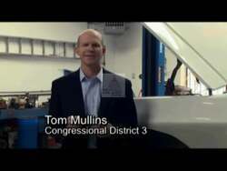 ["In a 2010 political TV ad, Republican congressional candidate Tom Mullins emphasized his strong opposition to excessive governmental regulations, particularly cap-and-trade policies, suggesting they harm job growth. Throughout the ad, Mullins, in business attire, confidently addresses the camera against backdrops like oil rigs and the New Mexican landscape, asking for votes."]