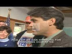 ["In the 1994 presidential campaign ad, Democratic Party candidate Dan Hamburg consistently and passionately advocates for substantial health care reform and domestic investment from various podiums in Congress. Throughout the ad, he emphasizes the importance of these reforms, including women's rights, addressing viewers with a confident and assertive demeanor."]