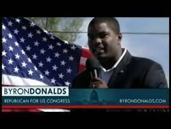 ["In his 2012 campaign ad, congressional candidate Byron Donalds speaks directly to the camera in various office settings, earnestly promoting economic reform. He stands confidently in a suit, with campaign posters subtly visible, expressing his disapproval of negative political ads while highlighting his dedication to addressing fiscal issues and national concerns."]