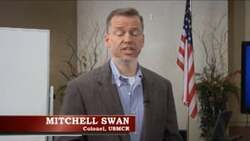 ["In the 2014 campaign ad, Mitchell Swan, a Marine Corps Colonel, discusses America's challenges, proposing his candidacy for Congress as a solution. Highlighting his military background, he emphasizes national improvement, fiscal responsibility, and strengthening military prowess while promoting change and leadership to address the issues facing the United States."]